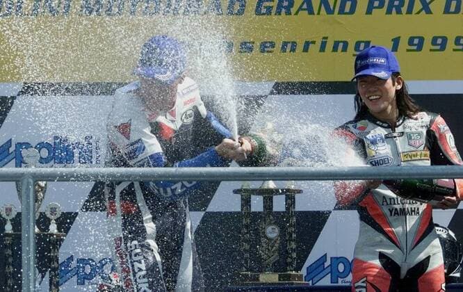 3rd placed Japanese rider Norick Abe, right, sprays Champagner on the winner of the 500cc race of German motor cycling World Cup at the Sachsenring circuit U.S. rider Kenny Roberts junior, left, during the winner ceremony on Sunday, July 18, 1999. ( Eckehard Schulz) SACHSENRING DEU