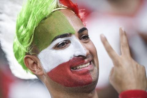 Iran fans wave slogans and national flags to show support to Iran national men s football team in their quarter-final match against China during the 2019 AFC Asian Cup in Abu Dhabi, United Arab Emirates, 24 January 2019. Iran fans cheer for quarter-final match against China  scr161772