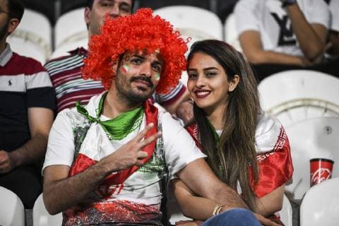 Iran fans wave slogans and national flags to show support to Iran national men s football team in their quarter-final match against China during the 2019 AFC Asian Cup in Abu Dhabi, United Arab Emirates, 24 January 2019. Iran fans cheer for quarter-final match against China  scr161758