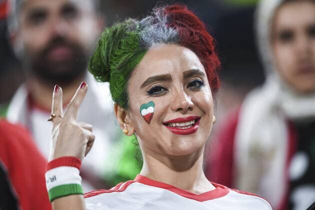 Iran fans wave slogans and national flags to show support to Iran national men s football team in their quarter-final match against China during the 2019 AFC Asian Cup in Abu Dhabi, United Arab Emirates, 24 January 2019. Iran fans cheer for quarter-final match against China  scr161784
