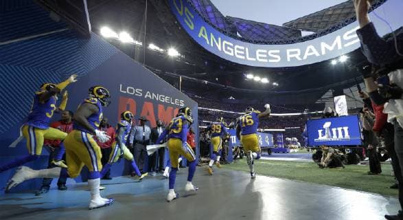 The Los Angeles Rams run onto the field to play the New England Patriots in Super Bowl LIII at Mercedes-Benz Stadium in Atlanta on February 3, 2019.  SBP20190203117 JOHNxANGELILLO