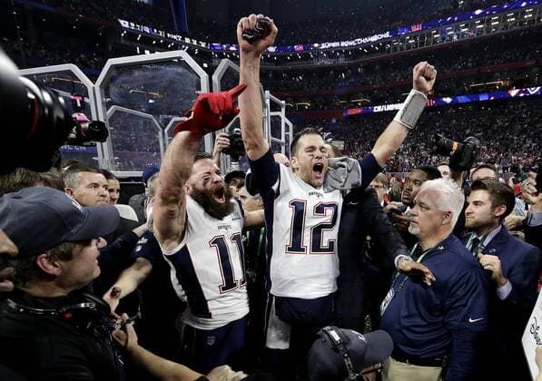 New England Patriots wide receiver Julian Edelman and Tom Brady celebrate after the game against the Los Angeles Rams at Super Bowl LIII at Mercedes-Benz Stadium on February 3, 2019 in Atlanta. The Patriots defeated the Rams 13-3.  SBP201902033016 JOHNxANGELILLO