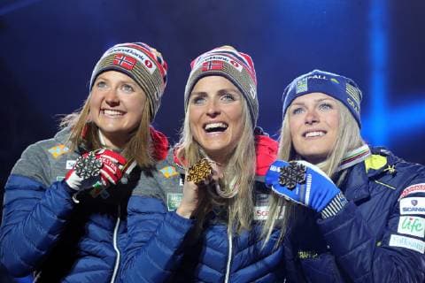 SEEFELD, TIROL, AUSTRIA â€“ MARCH 2, 2019: Cross-country skiers Ingvild Flugstad Ostberg (silver) of Norway, Therese Johaug (gold) of Norway, and Frida Karlsson (bronze) of Sweden, from left, pose at a medal ceremony for the ladies 30km mass start race at the 2019 FIS Nordic World Ski Championships. Sergei Bobylev TASS  TS0A2FC8