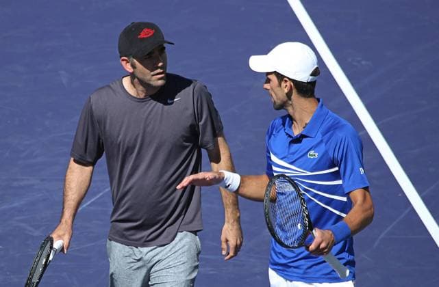 American Pete Sampras (L) and Novak Djokovic of Serbia talk to each other after a point during an exhibition match at the BNP Paribas Open in Indian Wells, California on March 16, 2019. The exhibition was arranged after the cancellation of the semifinals match between Roger Federer and Rafael Nadal due to a Nadal knee injury.  IDW201903167051 DAVIDxSILPA