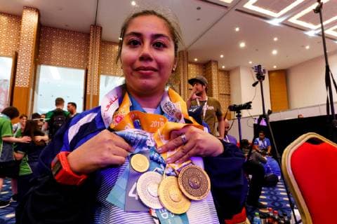March 17, 2019 - Abu Dhabi, United Arab Emirates - Athlete from El Salvador shows her medals during declaration ceremony at the Special Olympics World Games in Abu Dhabi National Exhibition Centre, United Arab Emirates on March 17, 2019. Special Olympics is a worldwide organization which organize sports competitions for people with learning difficulties. Summer World Games take place every 4 years. 7500 athletes from nearly 200 countries compete in 24 Olympic disciplines in Abu Dhabi Games in 2019. Special Olympics In Abu Dhabi 2019  - ZUMAn230 20190317_zaa_n230_743 Copyright: xDominikaxZarzyckax