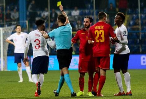 PODGORICA, MONTENEGRO - MARCH 25: Englandâ€™s Danny Rose receiving yellow card during the 2020 UEFA European Championships group A qualifying match between Montenegro and England at Podgorica City Stadium on March 25, 2019 in Podgorica, Montenegro. SPO, SOC, FOI 