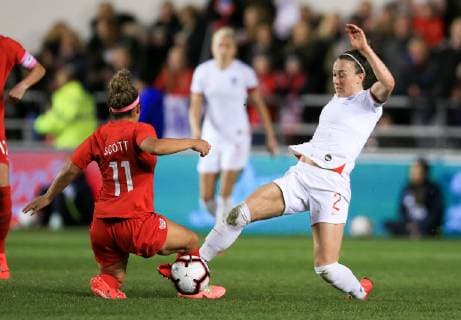 5th April 2019, Academy Stadium, Manchester, England; Womens International football friendly, England versus Canada; Desiree Scott of Canada tackles Lucy Bronze of England  ActionPlus12121031 DavidxBlunsden