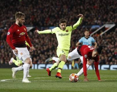 Sergi Roberto of Barcelona goes past a stumbling Chris Smalling of Manchester United ManU during the UEFA Champions League match at Old Trafford, Manchester. Picture date: 10th April 2019. Picture credit should read: Darren Staples Sportimage EDITORIAL USE ONLY. No use with unauthorised audio, video, data, fixture lists, club league logos or live services. Online in-match use limited to 120 images, no video emulation. No use in betting, games or single club league player publications. SPI-0026-0037
