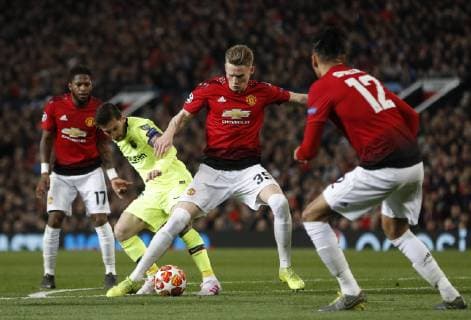 Scott McTominay of Manchester United ManU tackles Lionel Messi of Barcelona during the UEFA Champions League match at Old Trafford, Manchester. Picture date: 10th April 2019. Picture credit should read: Darren Staples Sportimage EDITORIAL USE ONLY. No use with unauthorised audio, video, data, fixture lists, club league logos or live services. Online in-match use limited to 120 images, no video emulation. No use in betting, games or single club league player publications. SPI-0026-0041