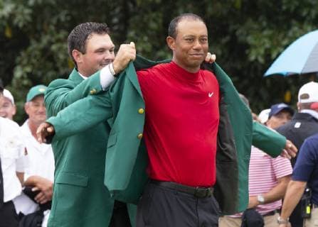 2018 champion Patrick Reed places the Green Jacket on Tiger Woods after the final round at the 2019 Masters Tournament at Augusta National Golf Club in Augusta, Georgia, on April 14, 2019. Tiger Woods wins the Masters with a score of 13 under par for his 5th Green Jacket.  AUG20190414921 JOHNxANGELILLO