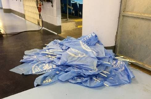 17th April 2019, Etihad Stadium, Manchester, England; UEFA Champions League football, quarter final 2nd leg, Manchester City versus Tottenham Hotspur; a pile of discarded Manchester City flags, which had been handed out to fans before the game, lay in the concourse at the Etihad after the match  ActionPlus12125163 DavidxBlunsden