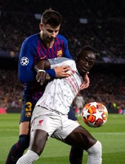 (190502) -- BARCELONA, May 2, 2019 -- FC Barcelona Barca s Gerard Pique (L) vies with Liverpool s Sadio Mane during the UEFA Champions League semifinal first leg soccer match between FC Barcelona and Liverpool in Barcelona, Spain, on May 1, 2019. Barcelona won 3-0. ) (SP)SPAIN-BARCELONA-SOCCER-UEFA CHAMPIONS LEAGUE-BARCELONA VS LIVERPOOL JoanxGosa 