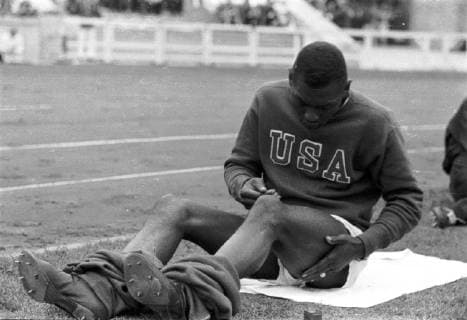 Summer Olympics 1936 - Germany, Third Reich - Olympic Games Olympische Spiele Olympia OS Summer Olympics 1936 in Berlin. Jesse Owens during a break at the Olympic arena. The most successful athlete of the Berlin Olympics. Gold medal winner in 100 m and 200 m sprint, 4 x 100 m relay and long jump. Image date August 1936. , Berlin Deutsches Reich Copyright: ErichxAndres UnitedArchives90062_00646343