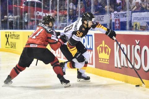 (190519) -- KOSICE, May 19, 2019 -- Jonathan Marchessault (L) of Canada tackles Markus Eisenschmid 58 of Germany during the 2019 IIHF Ice hockey, Eishockey World Championship, WM, Weltmeisterschaft Slovakia group A game between Canada and Germany at Steel Arena on May 18, 2019 in Kosice, Slovakia. Canada won 8-1. ) (SP)SLOVAKIA-KOSICE-ICE HOCKEY-IIHF-WORLD CHAMPIONSHIP-GROUP A-CAN VS GER LukaszxLaskowski 