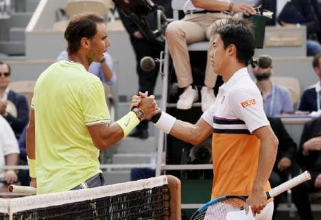 Tennis: French Open Rafael Nadal (L) of Spain shakes hands with Kei Nishikori of Japan after defeating him 6-1, 6-1, 6-3 in the quarterfinals of the French Open in Paris on June 4, 2019. 