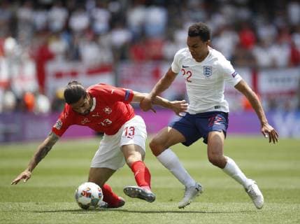Trent Alexander-Arnold of England tackles Ricardo Rodriguez of Switzerland during the UEFA Nations League match at D. Afonso Henriques Stadium, Guimaraes. Picture date: 9th June 2019. Picture credit should read: David Klein Sportimage EDITORIAL USE ONLY. No use with unauthorised audio, video, data, fixture lists, club league logos or live services. Online in-match use limited to 120 images, no video emulation. No use in betting, games or single club league player publications. SPI-0095-0023
