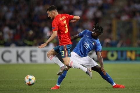 Aaron Caricol of Spain hurdles a challenge from Moise Kean of Italy during the UEFA Under-21 Championship 2019 match at Renato Dall Ara, Bologna. Picture date: 16th June 2019. Picture credit should read: Jonathan Moscrop Sportimage EDITORIAL USE ONLY. No use with unauthorised audio, video, data, fixture lists, club league logos or live services. Online in-match use limited to 120 images, no video emulation. No use in betting, games or single club league player publications. SPI-0100-0018