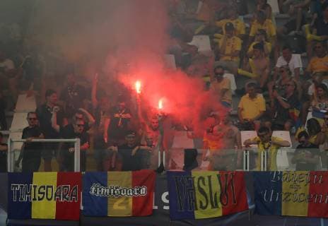 Romania fans light flares during the UEFA Under-21 Championship 2019 match at San Marino Stadium, Serravalle. Picture date: 21st June 2019. Picture credit should read: Jonathan Moscrop Sportimage EDITORIAL USE ONLY. No use with unauthorised audio, video, data, fixture lists, club league logos or live services. Online in-match use limited to 120 images, no video emulation. No use in betting, games or single club league player publications. SPI-0103-0008