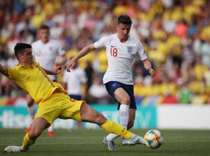 Alexandru Pascanu of Romania tackles Mason Mount of England during the UEFA Under-21 Championship 2019 match at San Marino Stadium, Serravalle. Picture date: 21st June 2019. Picture credit should read: Jonathan Moscrop Sportimage EDITORIAL USE ONLY. No use with unauthorised audio, video, data, fixture lists, club league logos or live services. Online in-match use limited to 120 images, no video emulation. No use in betting, games or single club league player publications. SPI-0103-0009