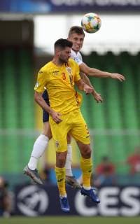 Florin-Bogdan Stefan of Romania challenged by Jonjoe Kenny of England during the UEFA Under-21 Championship 2019 match at San Marino Stadium, Serravalle. Picture date: 21st June 2019. Picture credit should read: Jonathan Moscrop Sportimage EDITORIAL USE ONLY. No use with unauthorised audio, video, data, fixture lists, club league logos or live services. Online in-match use limited to 120 images, no video emulation. No use in betting, games or single club league player publications. SPI-0103-0011