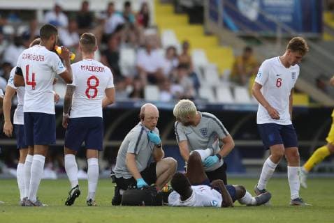 The England physio radios through to replace Ryan Sessegnon as he lies on the floor injured during the UEFA Under-21 Championship 2019 match at San Marino Stadium, Serravalle. Picture date: 21st June 2019. Picture credit should read: Jonathan Moscrop Sportimage EDITORIAL USE ONLY. No use with unauthorised audio, video, data, fixture lists, club league logos or live services. Online in-match use limited to 120 images, no video emulation. No use in betting, games or single club league player publications. SPI-0103-0015