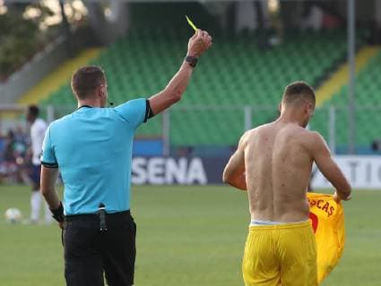 George Puscas of Romania receives a yellow card for taking his shirt off while celebrating during the UEFA Under-21 Championship 2019 match at San Marino Stadium, Serravalle. Picture date: 21st June 2019. Picture credit should read: Jonathan Moscrop Sportimage EDITORIAL USE ONLY. No use with unauthorised audio, video, data, fixture lists, club league logos or live services. Online in-match use limited to 120 images, no video emulation. No use in betting, games or single club league player publications. SPI-0103-0022