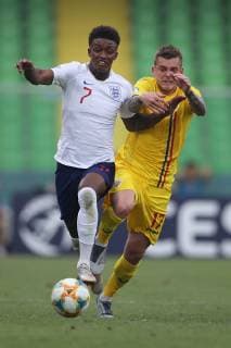 Demarai Gray of England and Alexandru Cicaldau of Romania during the UEFA Under-21 Championship 2019 match at Dino Manuzzi, Cesena. Picture date: 21st June 2019. Picture credit should read: Jonathan Moscrop Sportimage EDITORIAL USE ONLY. No use with unauthorised audio, video, data, fixture lists, club league logos or live services. Online in-match use limited to 120 images, no video emulation. No use in betting, games or single club league player publications. SPI-0103-0103