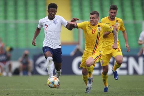 Demarai Gray of England and Alexandru Cicaldau of Romania during the UEFA Under-21 Championship 2019 match at Dino Manuzzi, Cesena. Picture date: 21st June 2019. Picture credit should read: Jonathan Moscrop Sportimage EDITORIAL USE ONLY. No use with unauthorised audio, video, data, fixture lists, club league logos or live services. Online in-match use limited to 120 images, no video emulation. No use in betting, games or single club league player publications. SPI-0103-0110