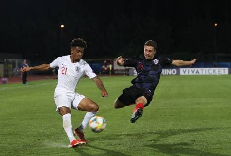 Reiss Nelson of England challenged by Marijan Cabraja of Croatia during the UEFA Under-21 Championship 2019 match at San Marino Stadium, Serravalle. Picture date: 24th June 2019. Picture credit should read: Jonathan Moscrop Sportimage EDITORIAL USE ONLY. No use with unauthorised audio, video, data, fixture lists, club league logos or live services. Online in-match use limited to 120 images, no video emulation. No use in betting, games or single club league player publications. SPI-0105-0024
