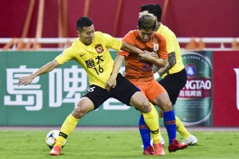 JINAN, CHINA - JUNE 25: Jin Jingdao 33 of Shandong Luneng and Huang Bowen 16 of Guangzhou Evergrande compete for the ball during the AFC Champions League Round of 16 2nd Leg match between Shandong Luneng and Guangzhou Evergrande at Jinan Olympic Sports Center Stadium on June 25, 2019 in Jinan, Shandong Province of China.  Copyright: xVCGx CFP111222842788 