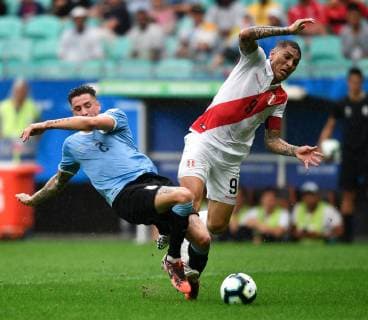 (190630) -- SALVADOR, June 30, 2019 -- Uruguay s Jose Maria Gimenez (L) competes with Paolo Guerrero of Peru during the Copa America 2019 quarterfinal match between Uruguay and Peru in Salvador, Brazil, June 29, 2019. Peru won 5-4 in penalty shoot-out. ) (SP)BRAZIL-SALVADOR-FOOTBALL-COPA AMERICA 2019-PERU VS URUGUAY XinxYuewei 