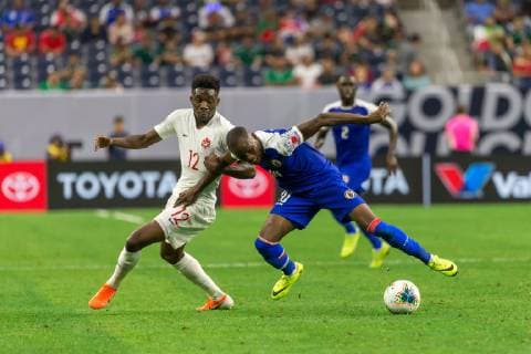 HOUSTON, TX - JUNE 29: Wilde-Donald Guerrier (10) of Haiti and Alphonso Davies (12) of Canada battle for the ball during the Quarterfinals match between Haiti and Canada as part of the 2019 CONCACAF Gold Cup on June 29, 2019, at NRG Stadium in Houston, Texas. (Photo by David Buono Icon Sportswire) SOCCER: JUN 29 CONCACAF Gold Cup Quarterfinals - Haiti v Canada Icon190629033