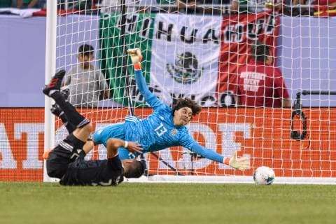 CHICAGO, IL - JULY 07: Mexico goalkeeper Guillermo Ochoa (13) dives for a ball in the first half during the CONCACAF Gold Cup final match between the United States and Mexico on July 07, 2019, at Soldier Field in Chicago, IL. (Photo By Daniel Bartel Icon Sportswire) SOCCER: JUL 07 CONCACAF Gold Cup Finals - USA v Mexico Icon190707004