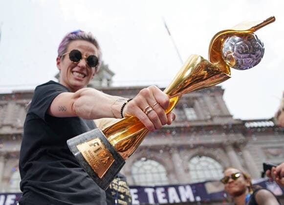 Megan Rapinoe of the United States Women s Soccer team celebrates with the Women s World Cup Trophy at City Hall after a Ticker Tape Parade at the Canyon Of Heroes on Wednesday, July 10, 2019 in New York City. Team USA defeated the Netherlands 2-0 to capture their second straight World Cup title.  NYP20190710123 JOHNxANGELILLO