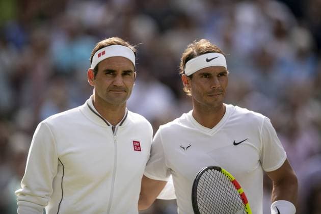 (190713) -- BEIJING, July 13, 2019 -- Roger Federer (L) of Switzerland and Rafael Nadal of Spain pose for a photo before their men s singles semi-final match at the 2019 Wimbledon Tennis Championships in London, Britain, on July 12, 2019. Roger Federer won 3-1. ) XINHUA PHOTOS OF THE DAY HanxYan 