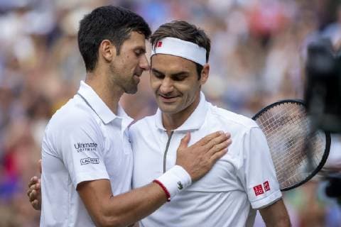 14th July 2019, The All England Lawn Tennis and Croquet Club, Wimbledon, England, Wimbledon Tennis Tournament, Day 13, mens singles final; Novak Djokovic (SER) speaks with Roger Federer (SUI) after he wins the match in a tie break of 5th set  ActionPlus12154031 ShaunxBrooks
