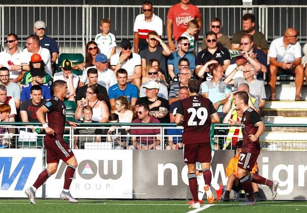 Copenhagen s Pieros Sotiriou (left) celebrates scoring his side s first goal of the game with team-mates during the UEFA Champions League second qualifying round first leg match at Park Hall Stadium, Oswestry. , Oswestry Denmark