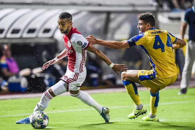 NICOSIA , 20-08-2019 , GSP Stadium , Champions League playoff, season 2019-2020 , Ajax player Hakim Ziyech, APOEL Nicosia player Nicholas Ioannou during the match APOEL Nicosia - Ajax APOEL Nicosia - Ajax  x4149537x Copyright: