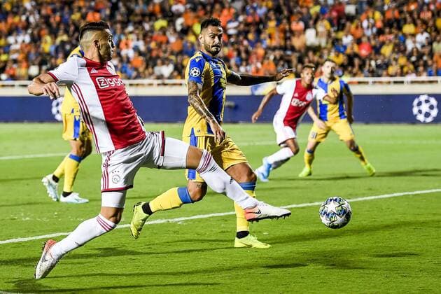 NICOSIA , 20-08-2019 , GSP Stadium , Champions League playoff, season 2019-2020 , Ajax player Dusan Tadic , APOEL Nicosia player Nicholas Ioannou during the match APOEL Nicosia - Ajax APOEL Nicosia - Ajax  x4149568x Copyright: