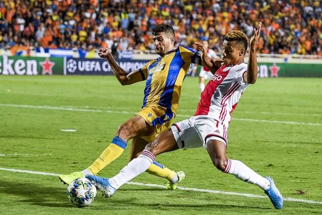 NICOSIA , 20-08-2019 , GSP Stadium , Champions League playoff, season 2019-2020 , APOEL Nicosia player Nicholas Ioannou, Ajax player David Neres during the match APOEL Nicosia - Ajax APOEL Nicosia - Ajax  x4149992x Copyright: