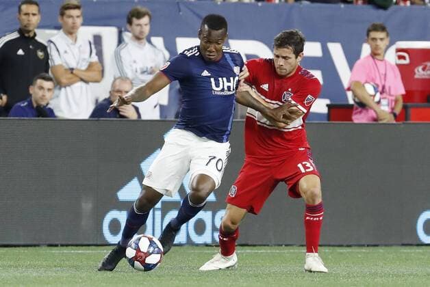 FOXBOROUGH, MA - AUGUST 24: New England Revolution forward Cristian Penilla (70) keeps the ball from Chicago Fire midfielder Brandt Bronico (13) during a match between the New England Revolution and the Chicago Fire on August 24, 2019, at Gillette Stadium in Foxborough, Massachusetts. (Photo by Fred Kfoury III Icon Sportswire) SOCCER: AUG 24 MLS, Fussball Herren, USA - Chicago Fire at New England Revolution Icon482190824012