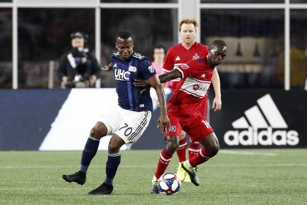 FOXBOROUGH, MA - AUGUST 24: Chicago Fire midfielder Michael Azira (16) pushes New England Revolution forward Cristian Penilla (70) off the ball during a match between the New England Revolution and the Chicago Fire on August 24, 2019, at Gillette Stadium in Foxborough, Massachusetts. (Photo by Fred Kfoury III Icon Sportswire) SOCCER: AUG 24 MLS, Fussball Herren, USA - Chicago Fire at New England Revolution Icon482190824015