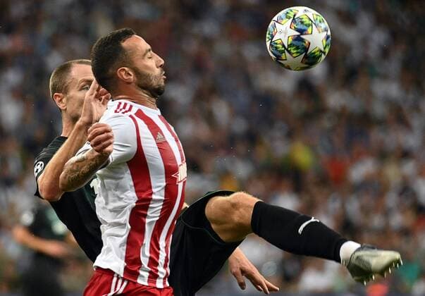 KRASNODAR, RUSSIA - AUGUST 27, 2019: Olympiacos FC s Guilherme Torres (front) and FC Krasnodar s Jon Gudni Fjoluson in the sesond leg of the 2019-20 UEFA Champions League play-off football match between FC Krasnodar and Olympiacos CFP at Krasnodar Stadium. Maxim Romanov TASS  TS0B832B