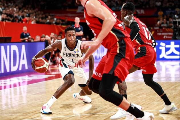 Frank Ntilikina, left, of France national basketball team passes the ball against players of Germany national basketball team in the first found match of group G during the 2019 FIBA Basketball World Cup in Shenzhen city, south China s Guangdong province, 1 September 2019. Orlando Magic shooting guard Evan Fournier s super performance helped France beat Germany 78-74 in a Group G encounter at the FIBA basketball World Cup on Sunday (1 September 2019). France edges Germany 78-74 in FIBA basketball World Cup  745557939877707790