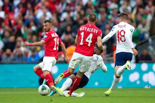 Danny Rose of England fouls Anton Nedyalkov of Bulgaria during the European 2020 Championship Qualifying match at Wembley Stadium, London. Picture date: 7th September 2019. Picture credit should read: James Wilson Sportimage EDITORIAL USE ONLY. No use with unauthorised audio, video, data, fixture lists, club league logos or live services. Online in-match use limited to 120 images, no video emulation. No use in betting, games or single club league player publications. SPI-0193-0028