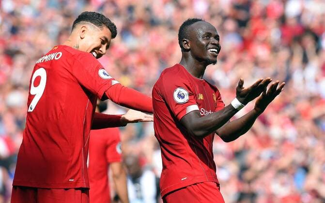 Sadio Mane of Liverpool celebrates scoring his goal to make it 2-1 with team mate Roberto Firmino of Liverpool during the Premier League match at Anfield, Liverpool. Picture date: 14th September 2019. Picture credit should read: Robin Parker Sportimage EDITORIAL USE ONLY. No use with unauthorised audio, video, data, fixture lists, club league logos or live services. Online in-match use limited to 120 images, no video emulation. No use in betting, games or single club league player publications. SPI-0196-0031