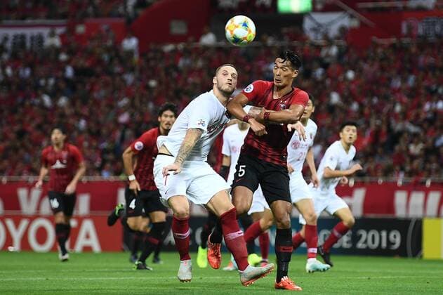 Austrian football player Marko Arnautovic of Shanghai SIPG F.C., left, and Japanese football player Tomoaki Makino of Urawa Red Diamonds, right, jump for the head ball during the second-round match of quarterfinal of AFC Champions League (ACL) in Saitama Prefecture, Japan, 17 September 2019. The second-round match of quarterfinal of AFC Champions League (ACL) between Urawa Red Diamonds and Shanghai SIPG ended with a 1-1 tie in Saitama Prefecture, Japan, 17 September 2019.