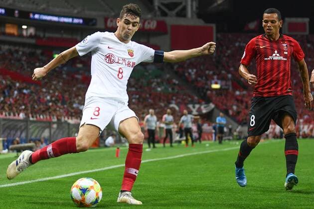 Brazilian football player Oscar dos Santos Emboaba Junior, better known as simply Oscar, of Shanghai SIPG F.C., left, keeps the ball while defended by Brazilian footballer Ewerton da Silva Pereira, known as Ewerton, of Urawa Red Diamonds, right, during the second-round match of quarterfinal of AFC Champions League (ACL) in Saitama Prefecture, Japan, 17 September 2019. The second-round match of quarterfinal of AFC Champions League (ACL) between Urawa Red Diamonds and Shanghai SIPG ended with a 1-1 tie in Saitama Prefecture, Japan, 17 September 2019.