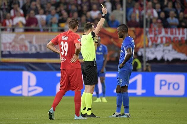 Genk s Aly Mbwana Samatta receives a yellow card from referee Felix Zwayer during a game between Austrian club RB Salzburg and Belgian RC Genk, Tuesday 17 September 2019 in Salzburg, Austria, first match in the group stage of the UEFA Champions League. YORICKxJANSENS  x05666063x