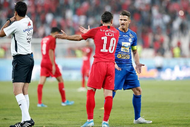 Farshad Ahmadzadeh of Perspolis and Voria Ghafouri of Esteghlal player clash during the persian gulf pro league match between Perspolis FC and Esteghlal FC at Azadi Stadium on Sep 22, 2019 in Tehran, Iran.(Photo By Amirhossein Kheirkhah) 